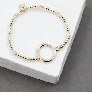 Beaded gold stretchy bracelet with bold circle detail