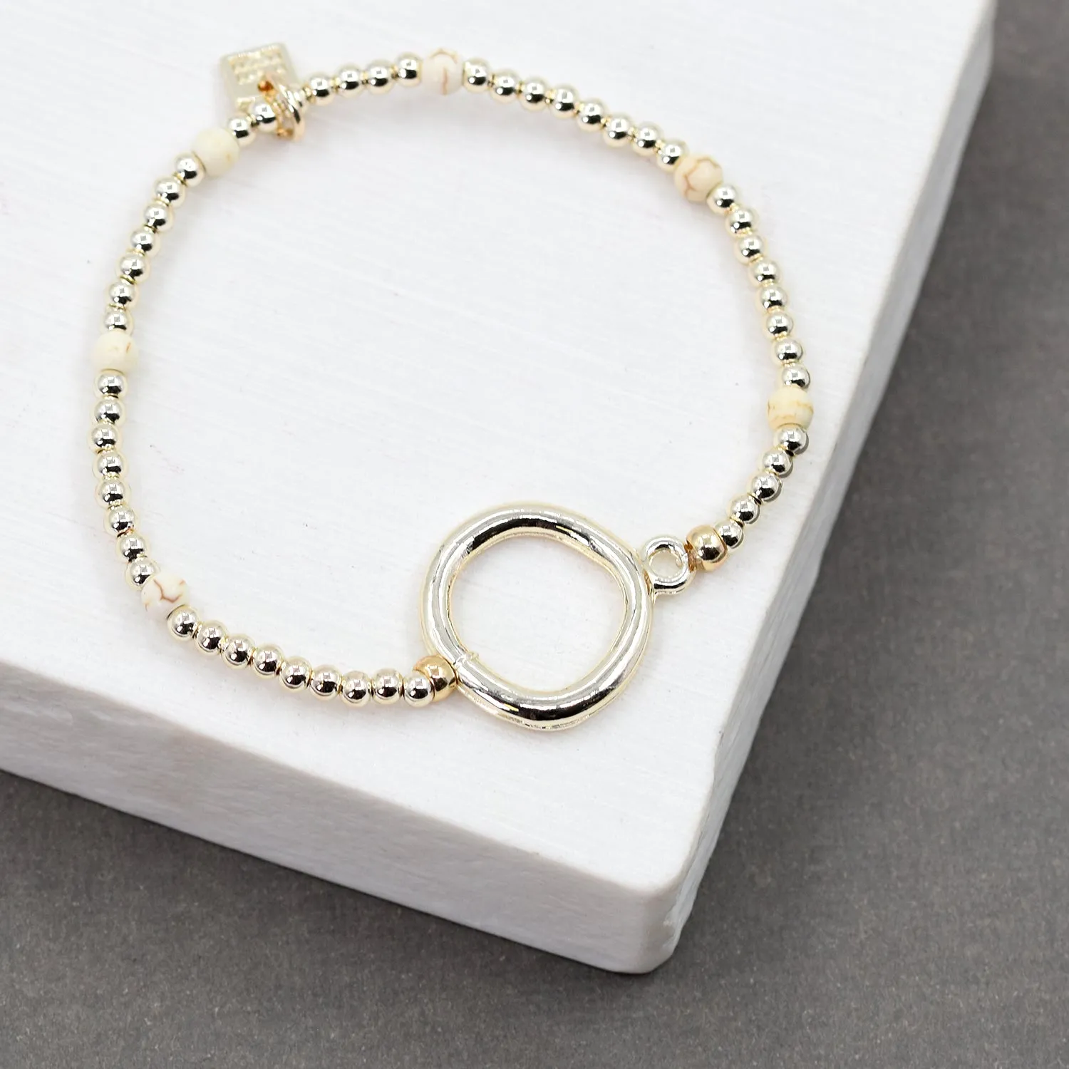 Beaded gold stretchy bracelet with bold circle detail